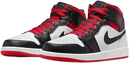 a pair of black and white sneakers with red laces