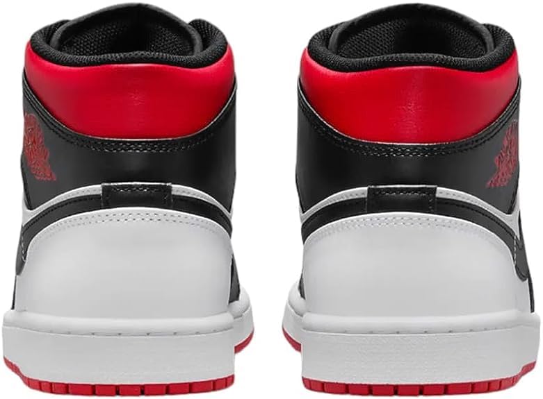 a pair of sneakers with red and black soles