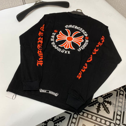 a black long sleeve shirt with an orange and white design