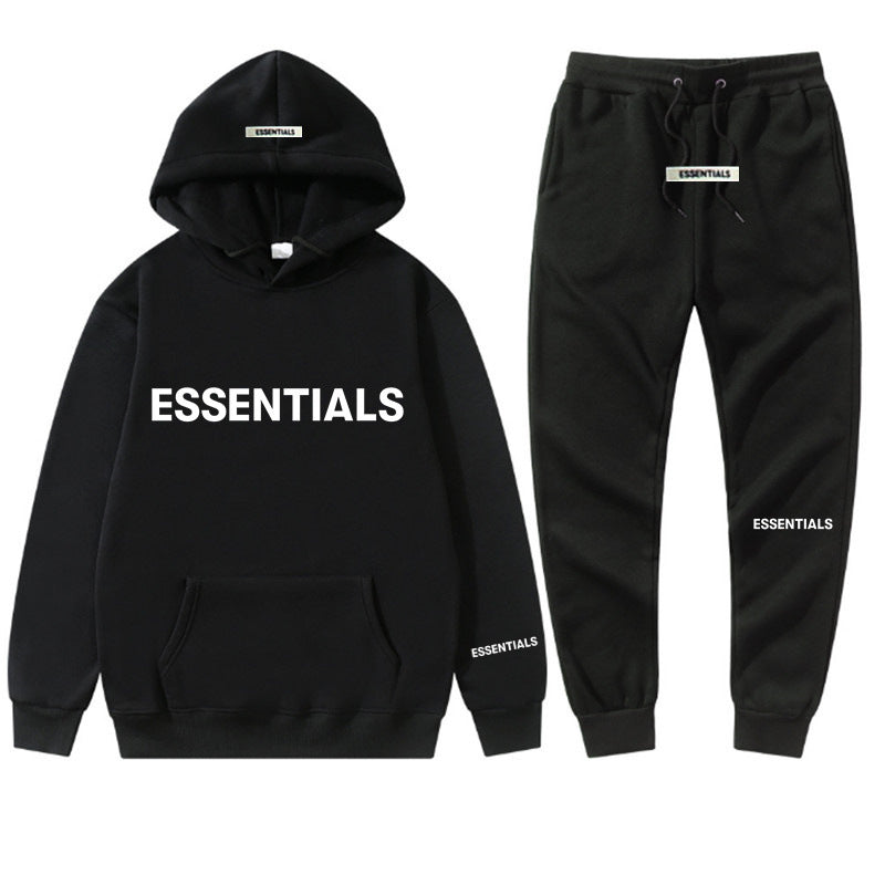 a black hoodie and sweatpants with the words essentials printed on it