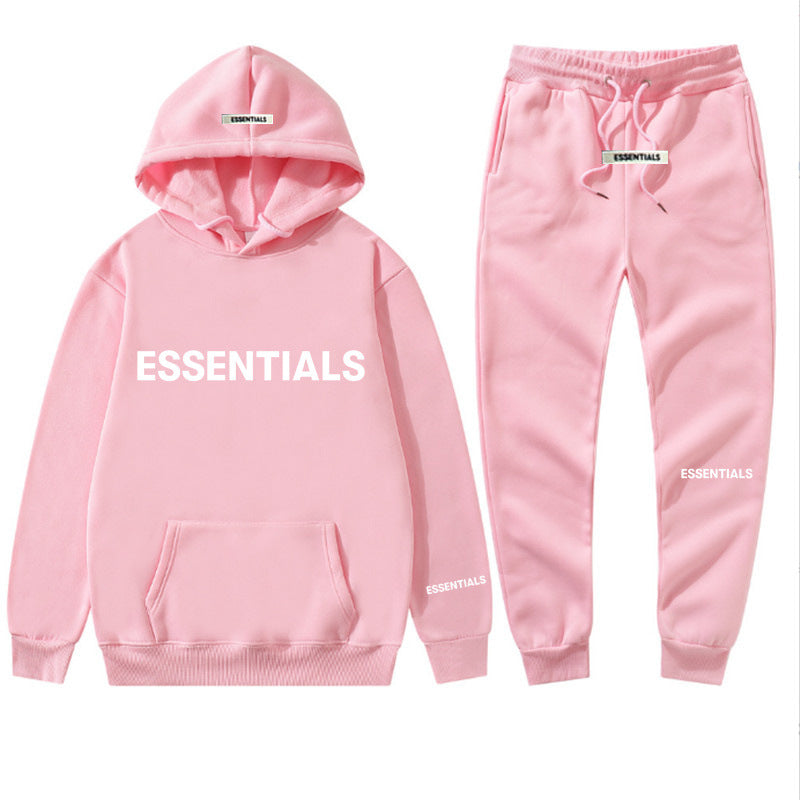 a pink hoodie and sweatpants with the words essentials printed on it