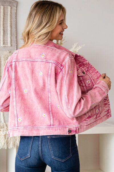 a woman wearing a pink jean jacket and jeans