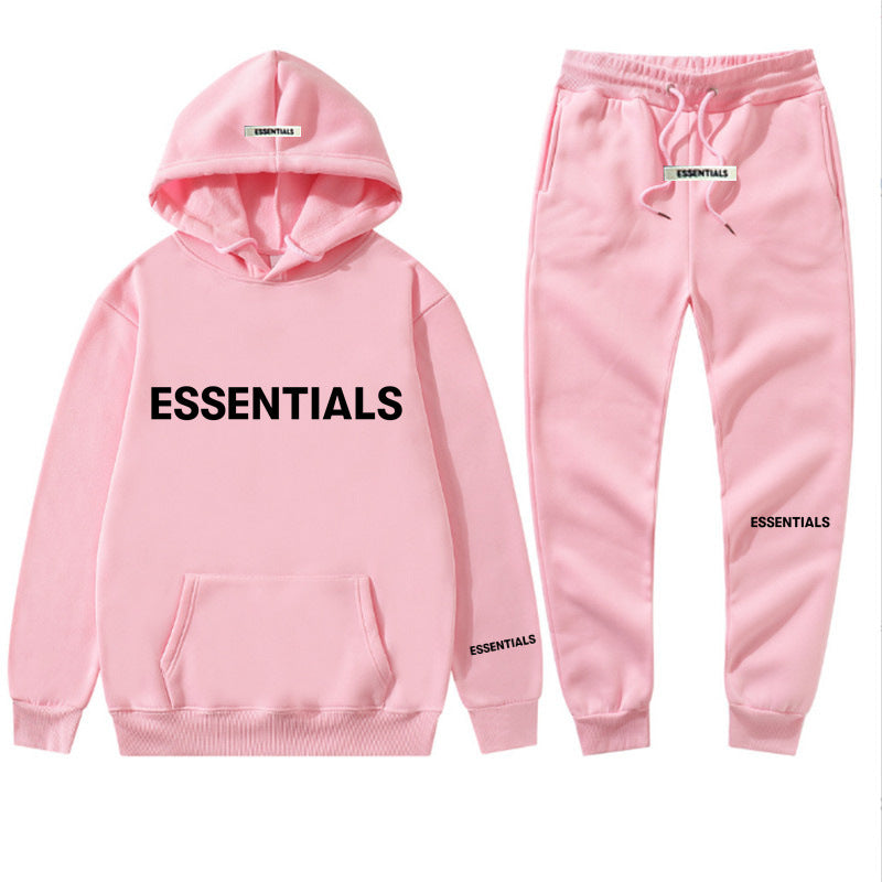 a pink hoodie and sweatpants with the words essentials printed on it