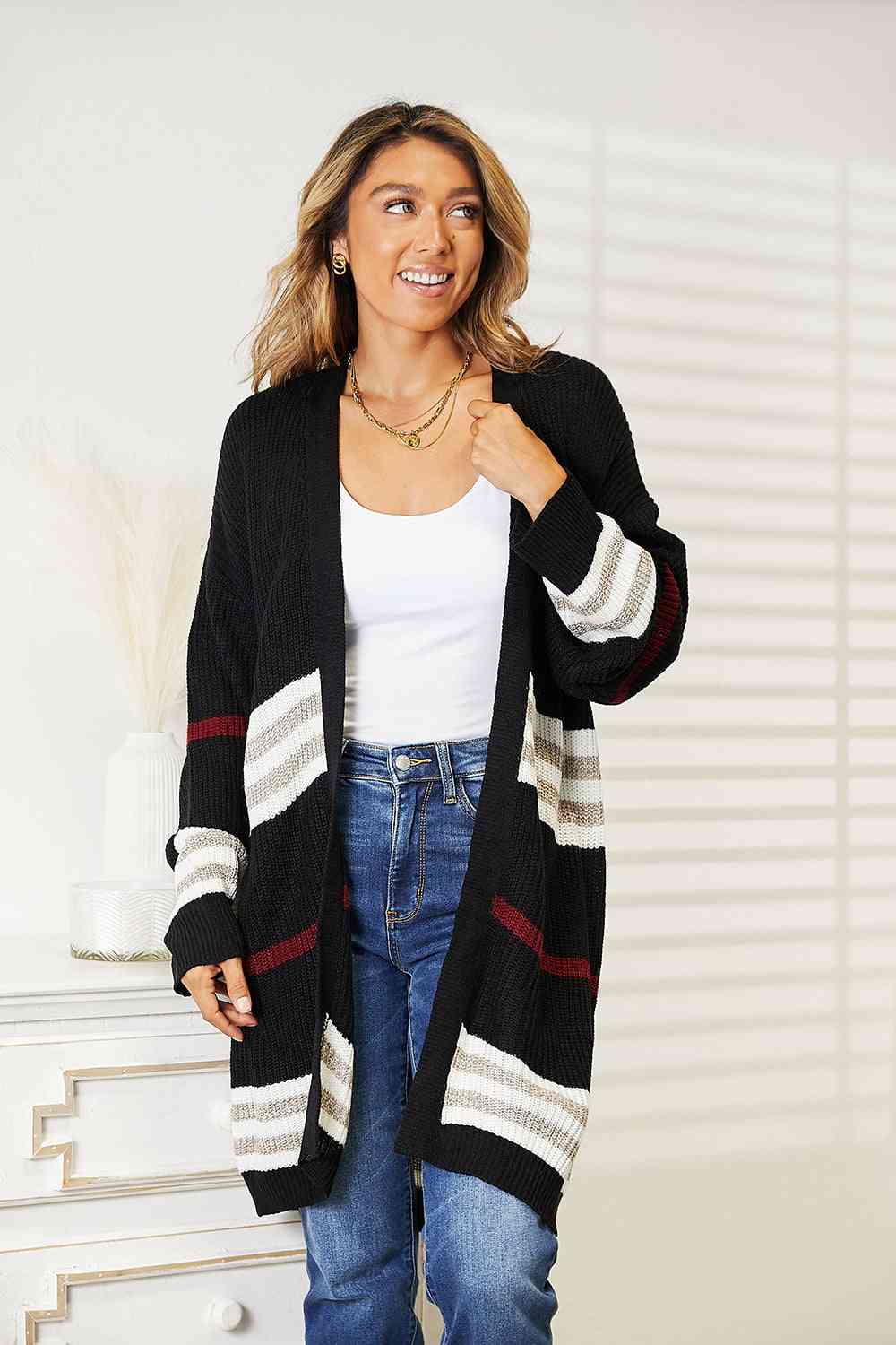 a woman wearing a black and white striped cardigan