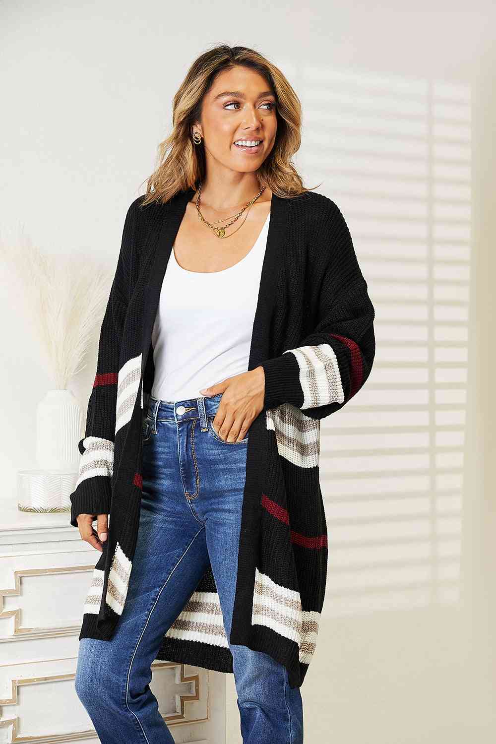 a woman wearing a black and white striped cardigan