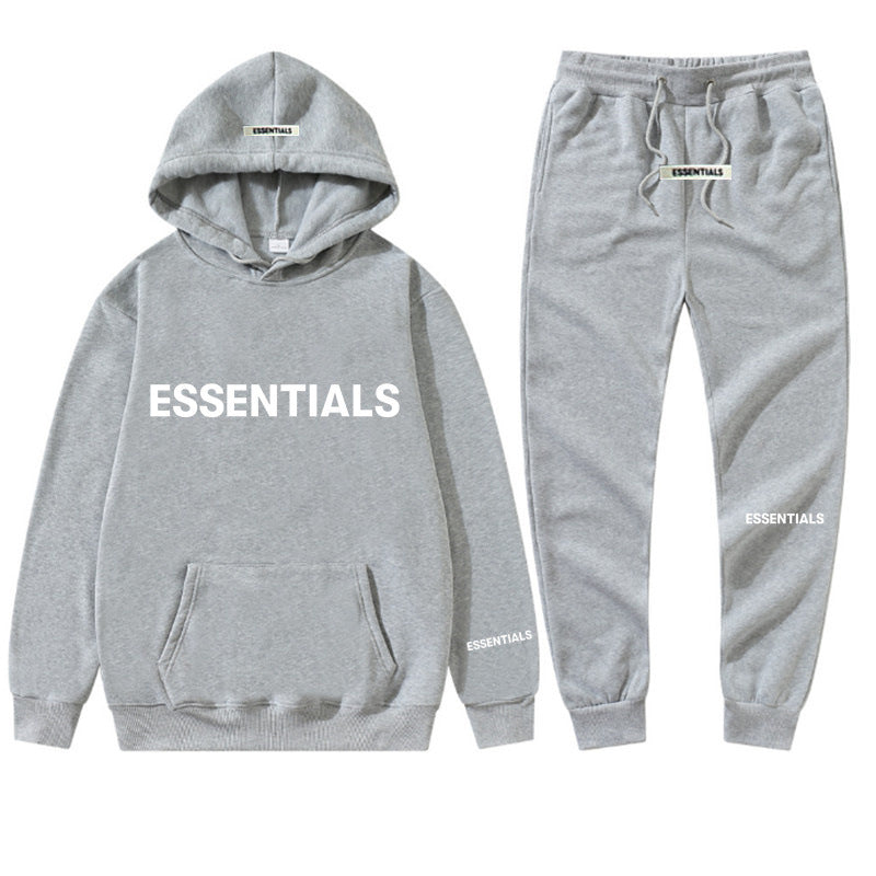 a grey sweatshirt and sweatpants with the words essentials printed on it